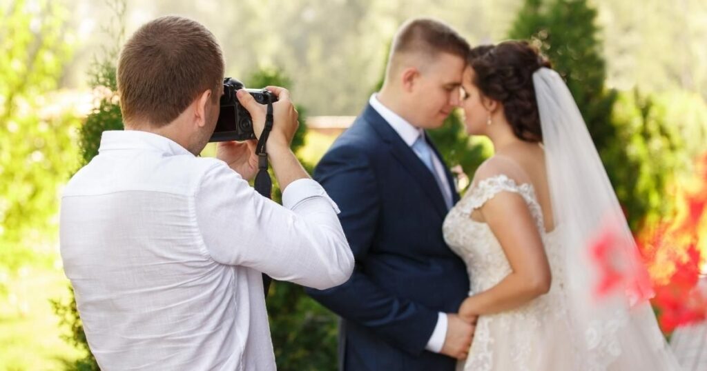 Wedding photographer taking photos of bride and groom